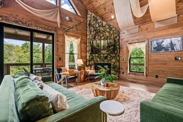 Green velvet, black-framed windows, and the deck one step away. Coffee inside, mountain air outside, no decision required.