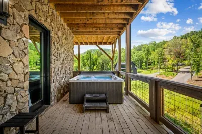 Soak under the timber-covered deck with mountain views stretching past the rail. First one in at dusk wins the best seat in the house.