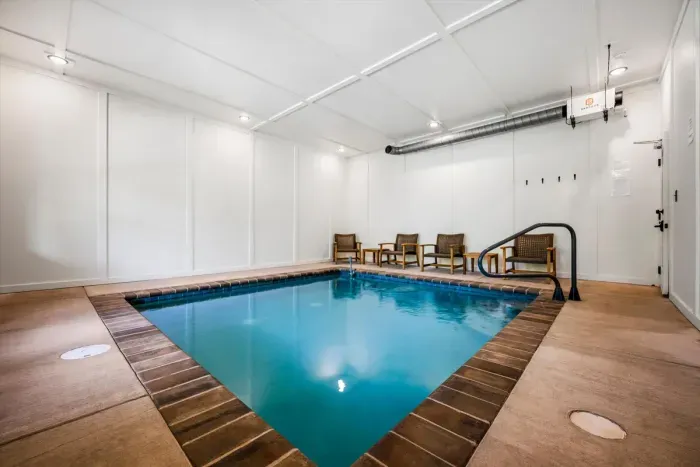 Private indoor pool with lounge seating and easy-entry steps. Kids stay busy for hours; the adults get the deck to themselves.