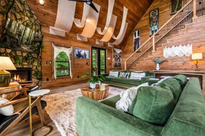 A crackling fireplace with mountain views behind it. Pull the throw over your legs and stay put — this room is the reason people rebook.