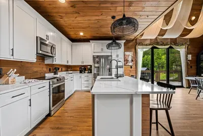 Stainless range, full-size refrigerator, and real counter space to work on. Stock up on the way in — this kitchen handles holiday-sized crowds.