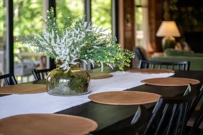 Table set and waiting. Bring the good bottle — this is the kind of dinner where nobody reaches for their phone.