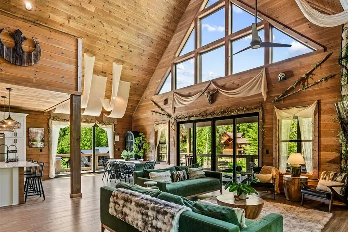 Open-concept living, dining, and kitchen under one soaring roofline. Cook, talk, and watch the forest without ever leaving the conversation.