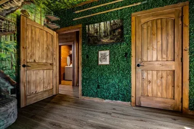 Moss-walled hallway leading into the bunk wing. The kind of detail that turns a stay into a memory instead of a booking.