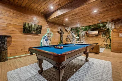 Regulation pool table under pine ceilings with mural walls all around. Bragging rights on the line every night of the stay.