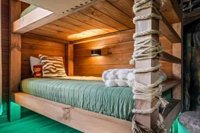 Rope-wrapped bunk beds with their own reading lights and floor glow. Sleeps the whole kid crew, and for once they'll want lights out.