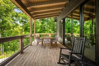 Covered deck with rocking chairs and an outdoor dining table. Rain or shine, this is the outdoor room you'll actually use every day.