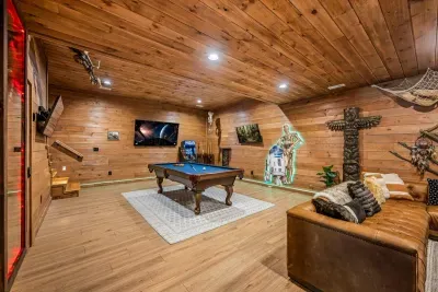 Pool table, big screen, and themed details top to bottom. Rainy forecast? Nobody in this house notices.
