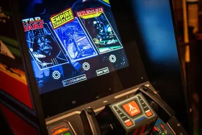 Retro arcade cabinet lit up and set to free play. First quarter's on us, since there aren't any.