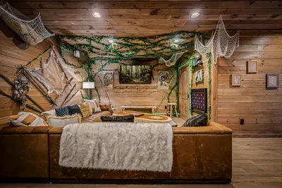 A canopy of vines overhead, a deep bed under fur throws, and a mounted TV. Themed suite that makes lights-out part of the trip.