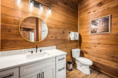 Full guest bath on this level, so nobody's climbing stairs at two in the morning.