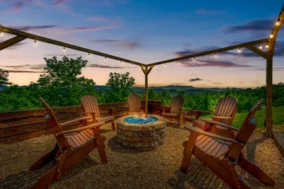 String lights, gas fire pit, and a ring of Adirondack chairs