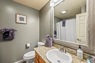 Full guest bath with granite vanity and tub-shower combo