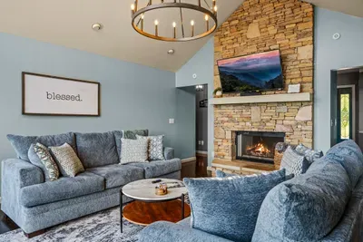 Iron chandelier, lit fireplace, sectional built for a crowd