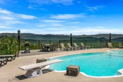 Diving board, a real deep end, and a mountain range behind it