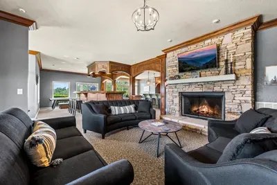 Stacked-stone fireplace, big TV, sectionals all around