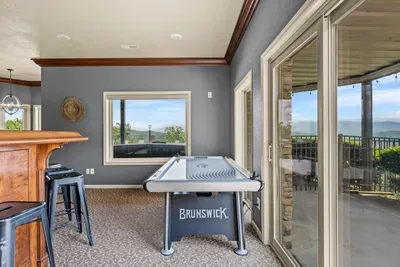 Air hockey by the bar, mountains just past the glass