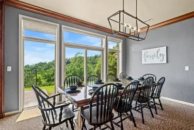 One long table, a dozen chairs, ridgeline out the glass