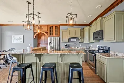 A second full kitchen with an island and bar seating