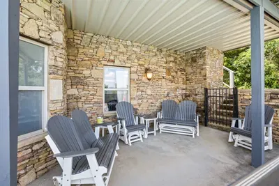 Covered stone porch with rockers, works rain or shine