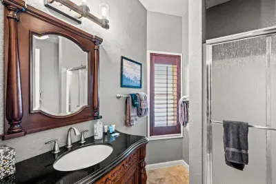 Walk-in shower and a carved wood vanity