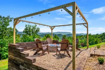 Chairs in a circle, fire in the middle, mountains past the posts