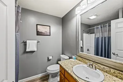 Bright guest bath with counter space for the toiletry pile