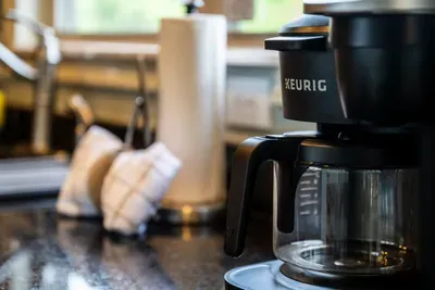 Keurig loaded, drip pot beside it, mugs already stocked