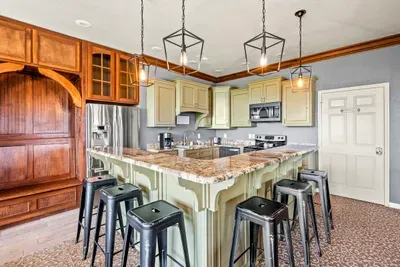 Island seating, pendant lights, and real prep space