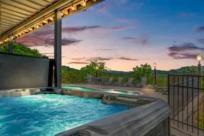 Sunset from the hot tub with string lights overhead