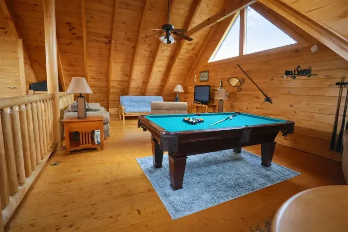 Billiards for fun, comfy couch for chill—upstairs living done right.