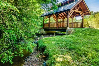 A quaint bridge, a flowing river, and nature doing its magic.