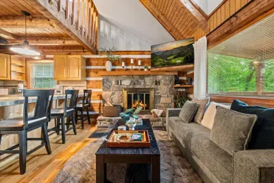 Sink into the sectional with the big screen on and a fire crackling under the stone hearth — vaulted ceilings overhead, room for everyone, nowhere you'd rather be. Movie night, sorted.