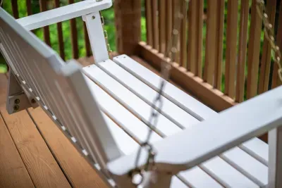 A classic porch swing strung up in the shade — the unofficial reading nook, nap spot, and "just five more minutes" chair all in one. Sway slow and watch the afternoon drift by.