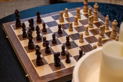 A wooden chess set stands ready for a slow, screen-free showdown — the kind of unhurried evening this cabin was built for. Your move; the mountains aren't going anywhere.