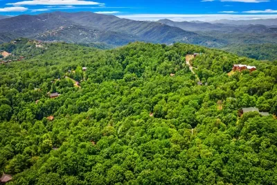 Unobstructed Blue Ridge mountain panorama from your private ridge-top cabin — clear days like this stretch all the way to the horizon. Breathe it in.