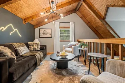 Sink into the loft's velvet sofa beneath a starburst chandelier and a soft mountain glow — the grown-ups' hideaway above the action. Faux-fur throws and good company included.