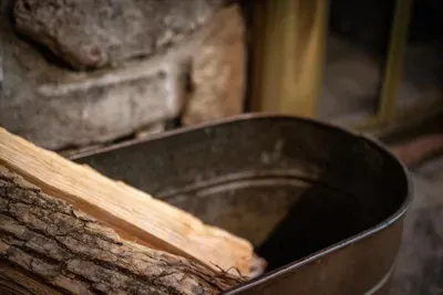 Rustic touches everywhere you look — even the firewood lives in a vintage galvanized tub by the hearth. The handmade details that make this cabin feel collected, not decorated.