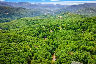 Layer after layer of Blue Ridge ridgelines fading into the blue — this is the view from your deck on a clear morning, coffee in hand, nowhere to be.
