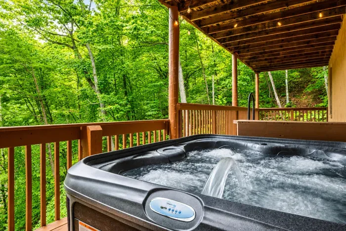 A private hot tub waits on the covered deck, tucked into the canopy and ready whenever you are. Peel back the cover, ease in, and let the mountain air do the rest.