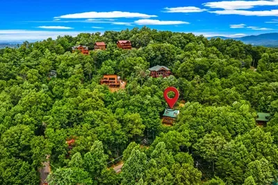 A sea of Blue Ridge green stretches to the horizon — your private mountain cabin is tucked right here, surrounded by forest, elevated above the everyday.