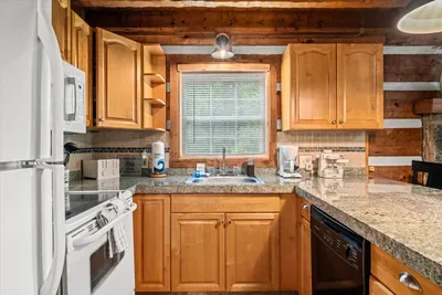 Granite counters, generous cabinet space, and a dishwasher to handle the cleanup — this kitchen is stocked to cook for the whole crew, not just reheat. Vacation meals, made easy.