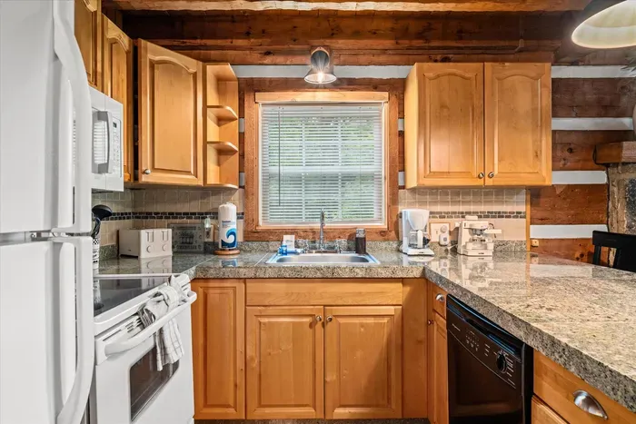 Granite counters, generous cabinet space, and a dishwasher to handle the cleanup — this kitchen is stocked to cook for the whole crew, not just reheat. Vacation meals, made easy.