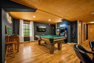 Enjoy hours of entertainment with a full-size pool table, classic arcade games, and a cozy lounge area—perfect for friendly competition and family game nights.