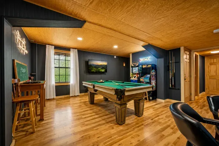 Enjoy hours of entertainment with a full-size pool table, classic arcade games, and a cozy lounge area—perfect for friendly competition and family game nights.