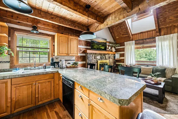 Cook with a view — granite counters, full log-cabin kitchen, and a picture window framing Blue Ridge ridgelines while you chop, sip, and savor.