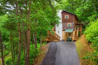 Wind up the private drive through the trees and the world goes quiet — the kind of tucked-away arrival that signals the real vacation has begun. No traffic, just treetops.