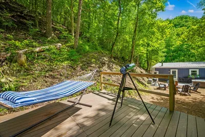 Hammock strung, telescope aimed, deck open to the treetops. Sway through the afternoon, then swing the scope up once the sky goes dark. Dark-sky nights up here are the real amenity.