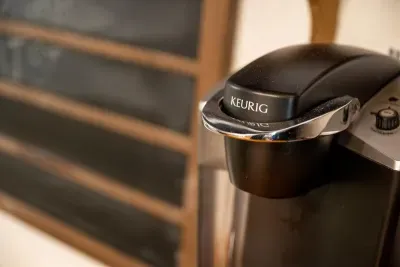 Keurig coffee bar stocked and waiting. Grab a mug, push the door open, and take that first sip on the porch before the day has any ideas. Best ten minutes up here.
