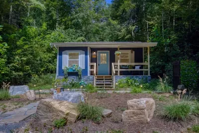 Stone path, planted beds, and a porch that catches the afternoon light. Pull in, unload once, and the rest of the weekend is entirely up to you.